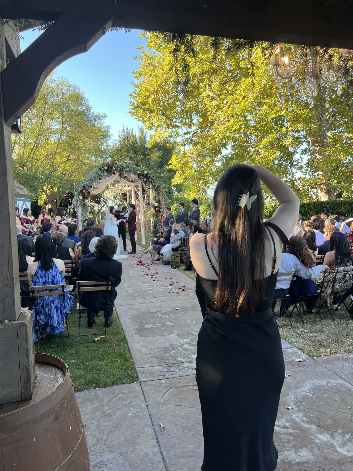 Caitlin at the back of the ceremony, capturing reference photos of the key moment